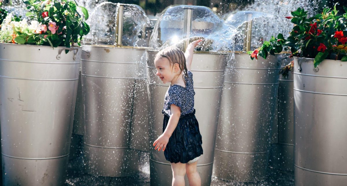 Girl playing in Park Place fountains.
